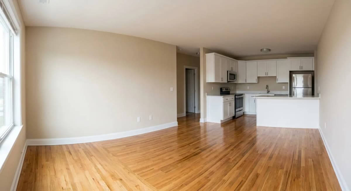 An empty rental living room and kitchen on move-out day, vacated and ready for a walkthrough inspection